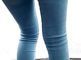 Pretty ass of a sexy woman in sky blue tight jeans