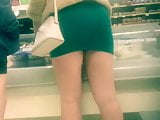 Blonde in a tight short dress showing legs
